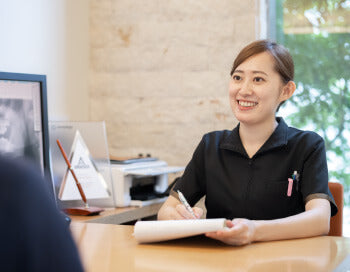 メモを取りながら話を聞く女性カウンセラー
