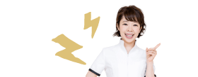 前歯を指さす女性スタッフ