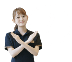 腕でバツ印を作る女性スタッフ
